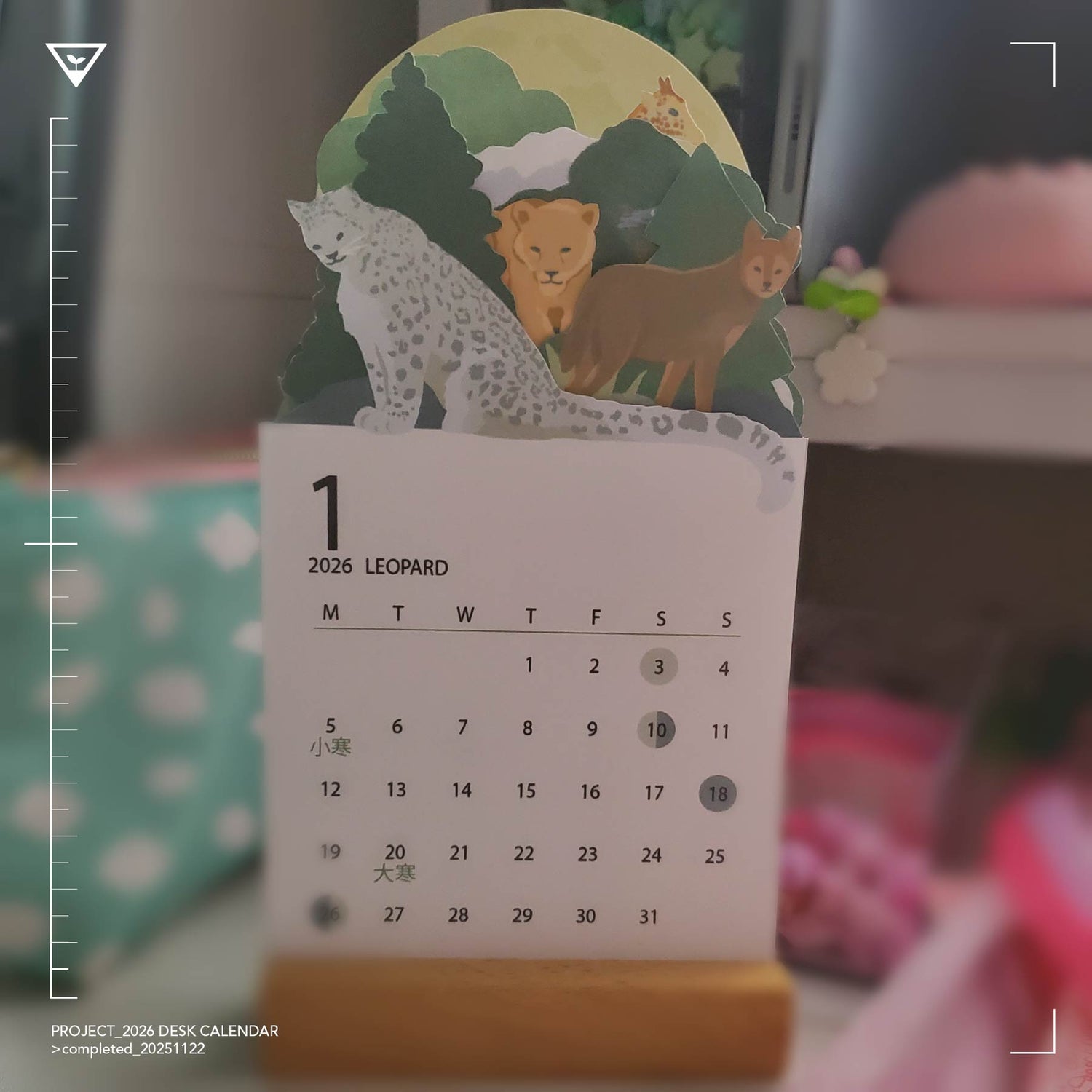 Desk calendar with animal illustrations on a blurred background